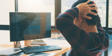 A programmer working on a computer
